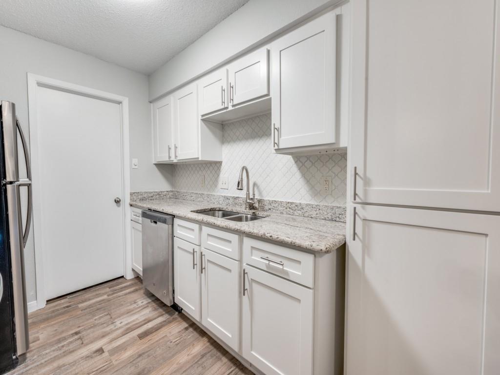 649 Timberline Drive Hurst, TX 76053 - Photo 20 of 29 a kitchen with granite countertop a sink stove and refrigerator