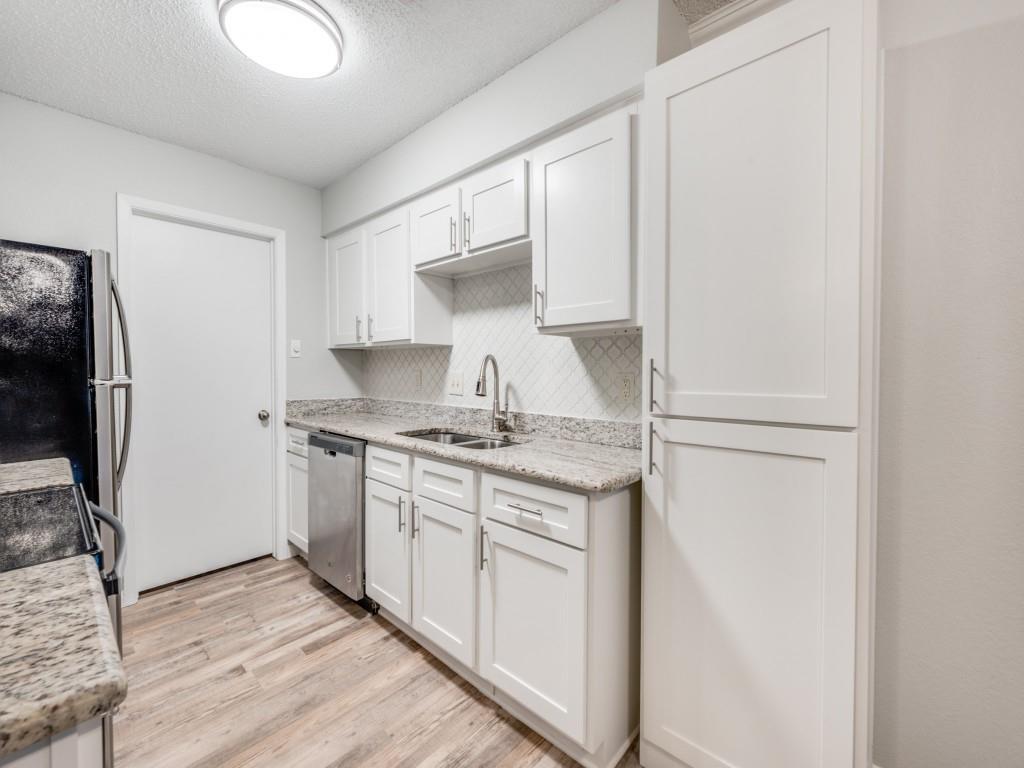 649 Timberline Drive Hurst, TX 76053 - Photo 21 of 29 a kitchen with stainless steel appliances granite countertop a stove a refrigerator and a sink