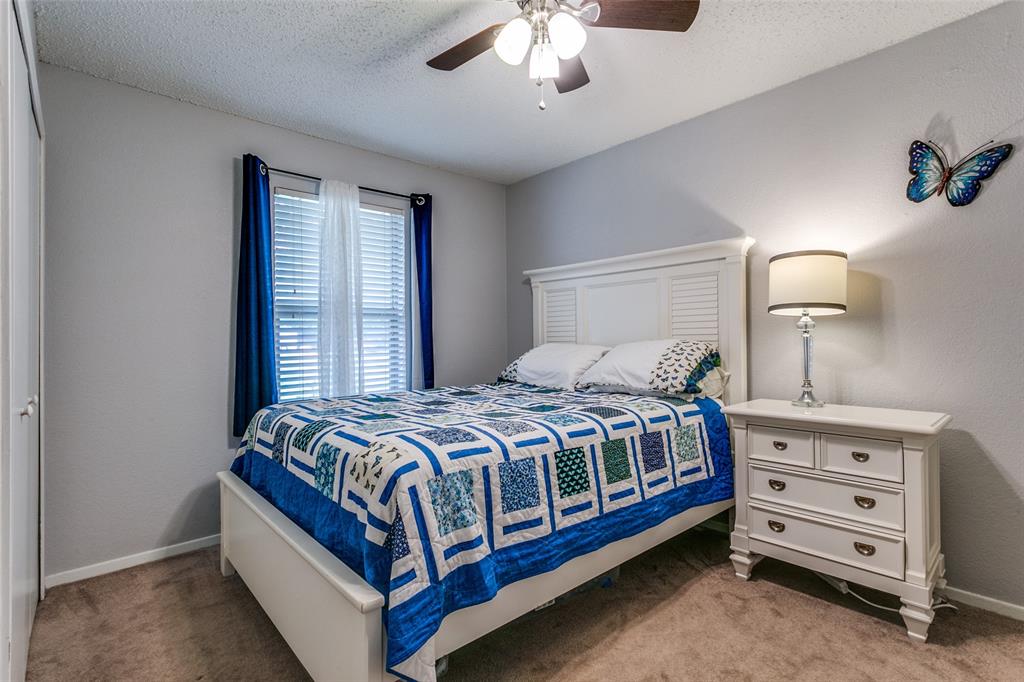 649 Timberline Drive Hurst, TX 76053 - Photo 26 of 29 a bedroom with a bed and a dresser