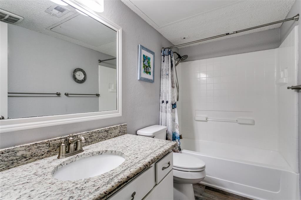 649 Timberline Drive Hurst, TX 76053 - Photo 28 of 29 a bathroom with a granite countertop sink toilet and shower