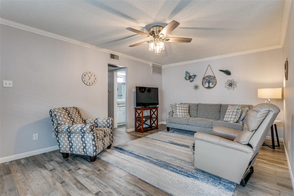649 Timberline Drive Hurst, TX 76053 - Photo 6 of 29 a living room with furniture and a flat screen tv with wooden floor