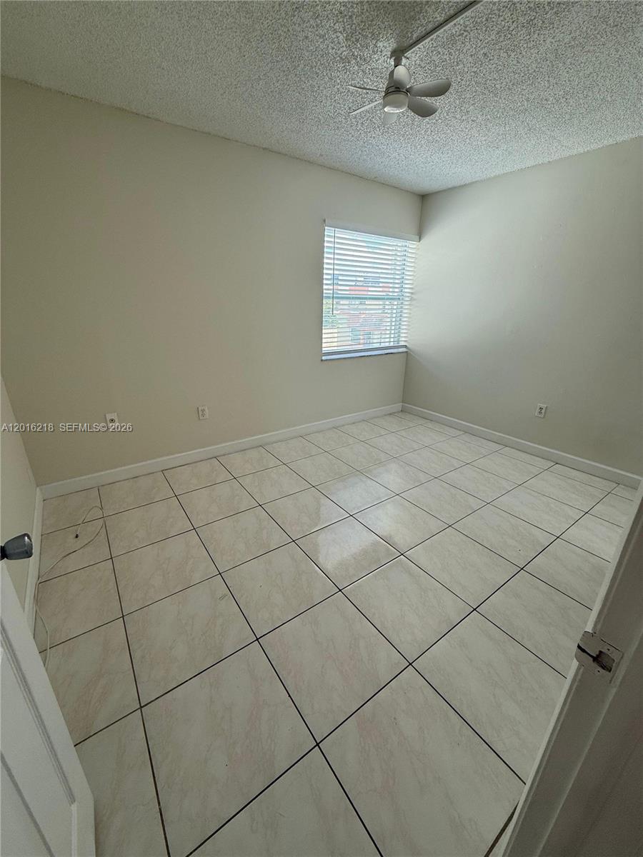 9321 Southwest 4th Street, Unit 230C Miami, FL 33174 - Photo 36 of 37 an empty room with windows