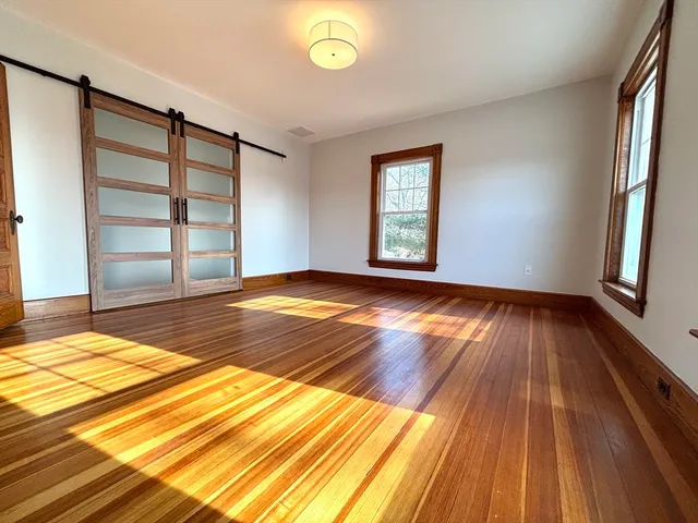 a view of wooden floor in a room with a window