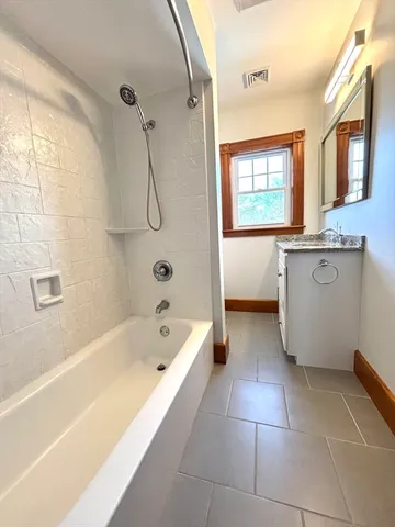 a bath tub sitting next to a bathroom sink