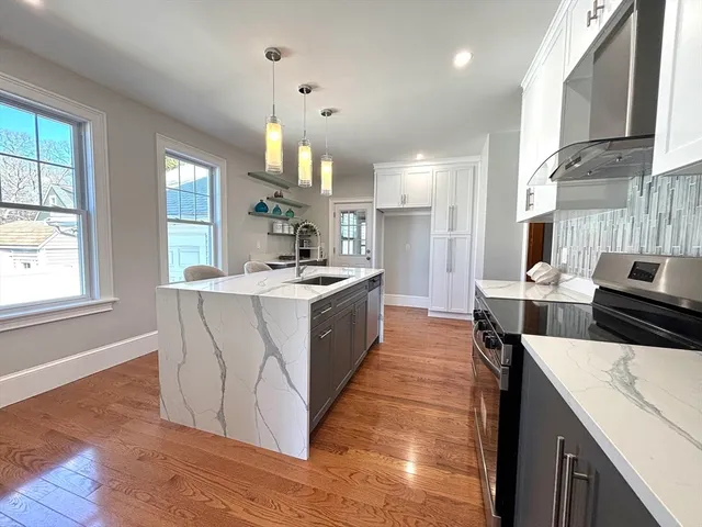 a kitchen with a sink stove and cabinets