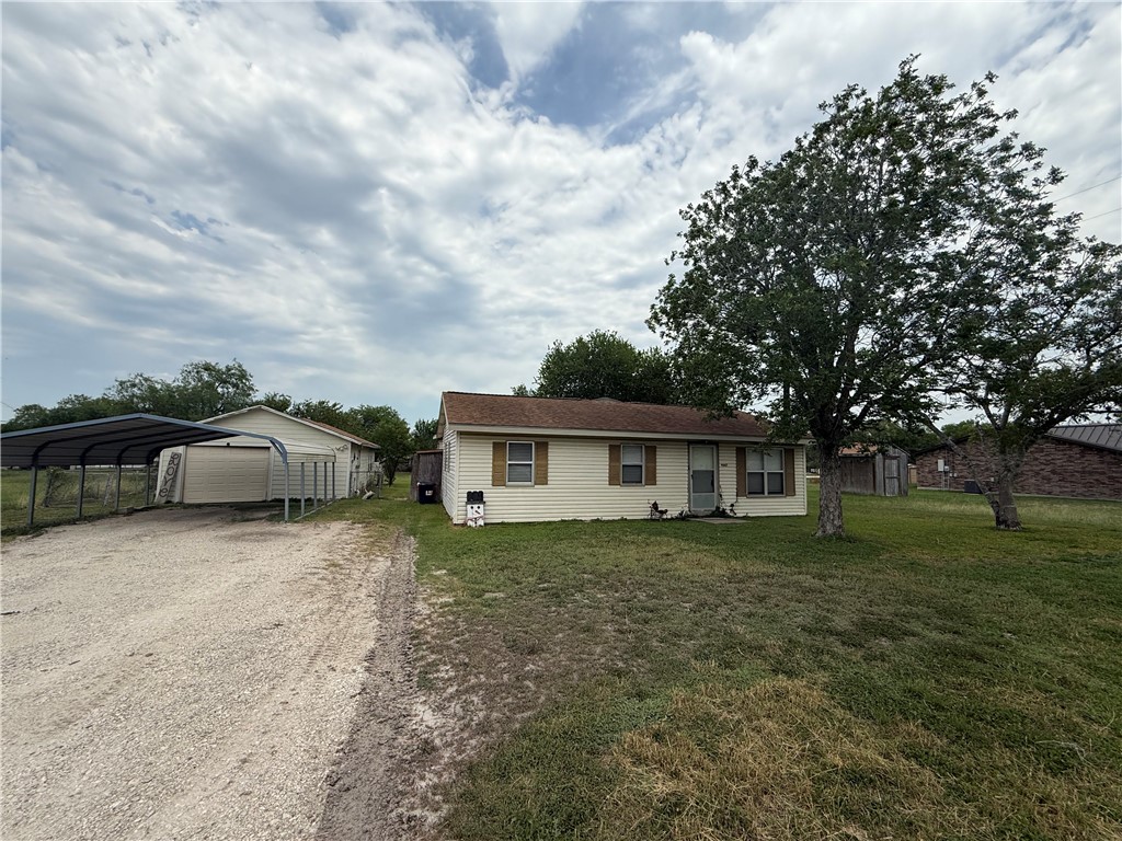 a front view of house with yard and trees
