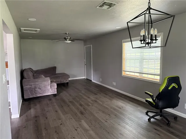 a view of a workspace with furniture and a window