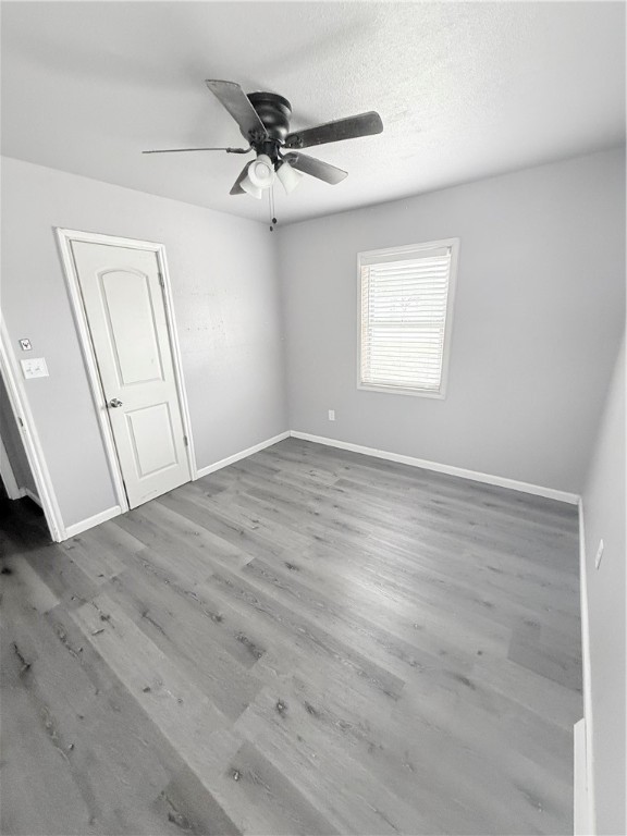 9047 County Road 471 Mathis, TX 78368 - Photo 18 of 21 an empty room with wooden floor fan and windows