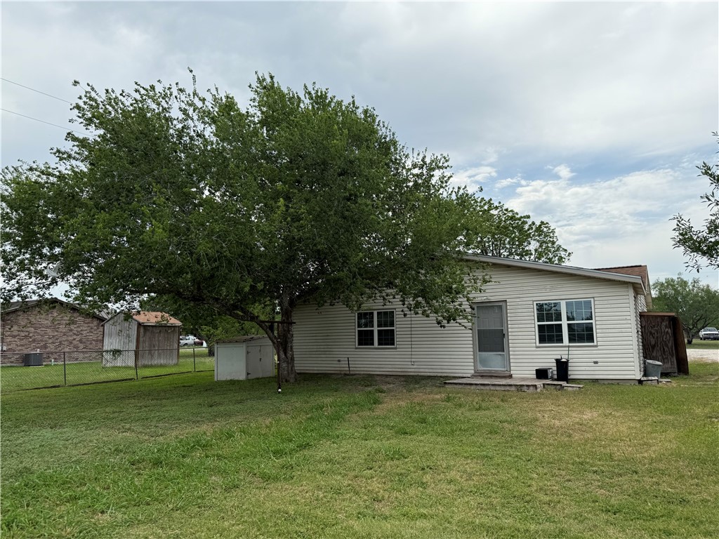 9047 County Road 471 Mathis, TX 78368 - Photo 2 of 21 a backyard of a house with plants and large tree