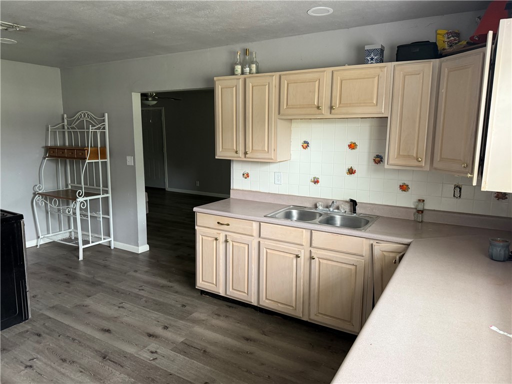9047 County Road 471 Mathis, TX 78368 - Photo 8 of 21 a kitchen with wooden cabinets sink and refrigerator