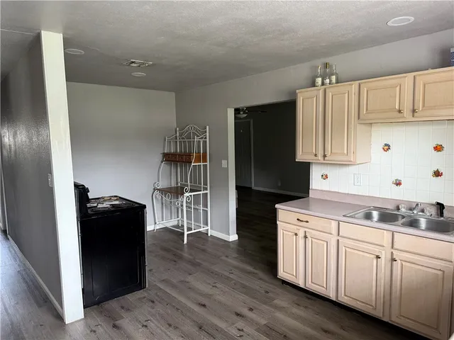 a kitchen with a refrigerator and a stove