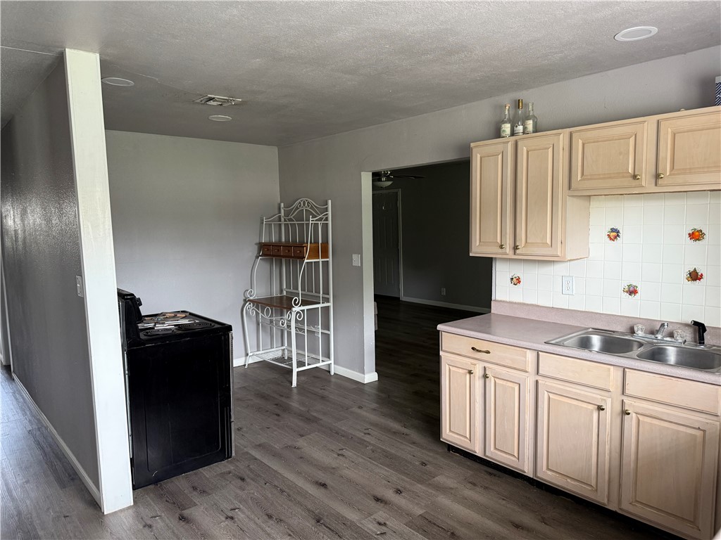 9047 County Road 471 Mathis, TX 78368 - Photo 9 of 21 a kitchen with a refrigerator and a stove