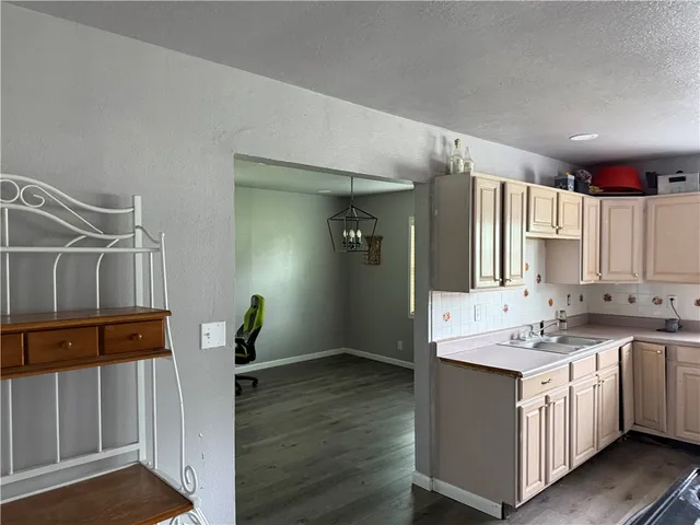 a kitchen with a sink cabinets and window