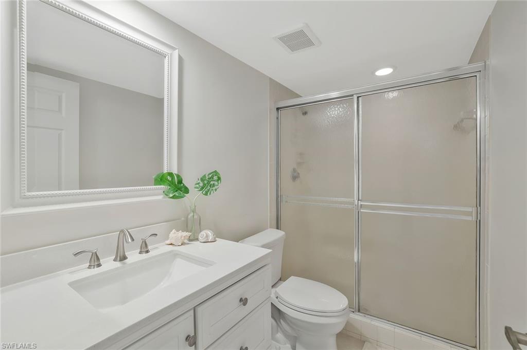 601 Augusta Boulevard, Unit 6014 Naples, FL 34113 - Photo 16 of 31 a bathroom with a sink toilet and shower