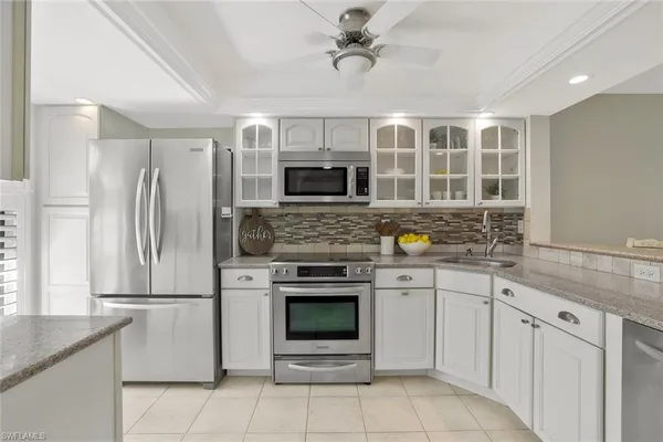 a kitchen with stainless steel appliances granite countertop a stove and a refrigerator