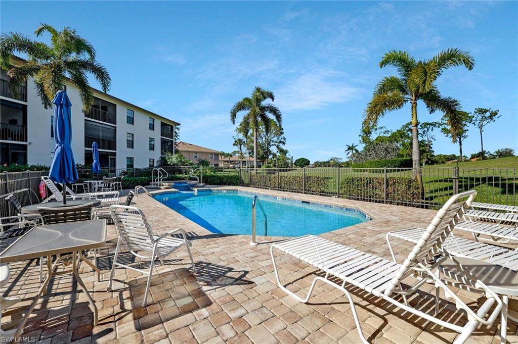 601 Augusta Boulevard, Unit 6014 Naples, FL 34113 - Photo 21 of 31 a view of a swimming pool with a lounge chairs