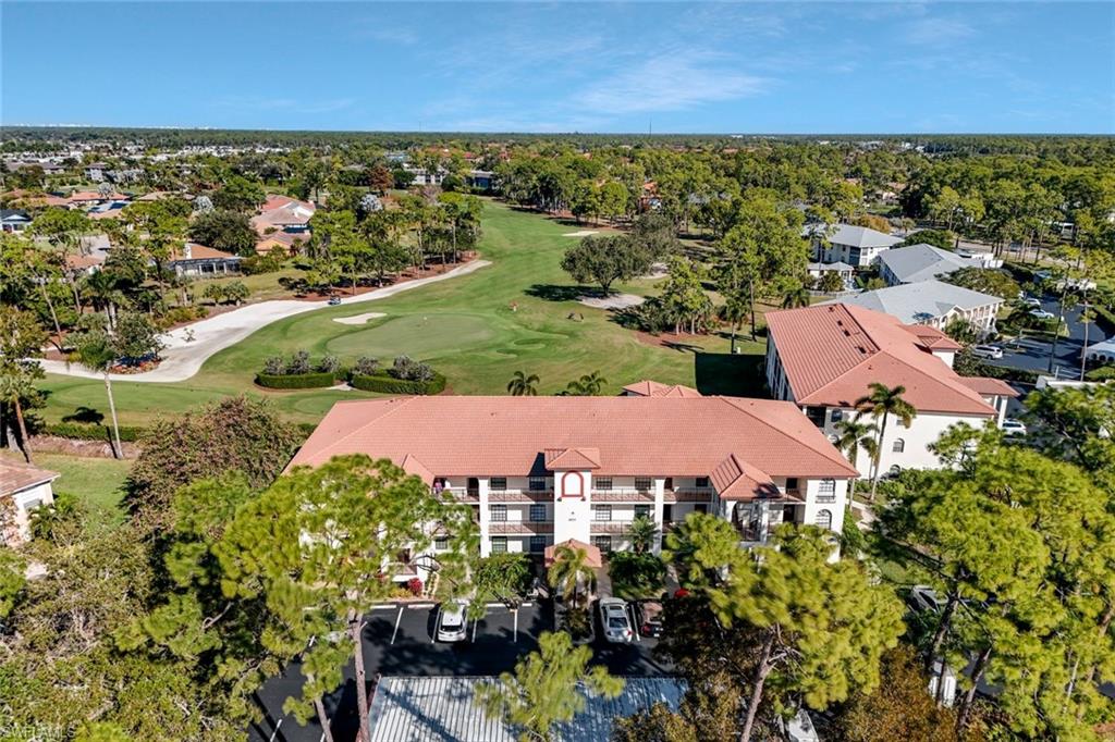 601 Augusta Boulevard, Unit 6014 Naples, FL 34113 - Photo 27 of 31 an aerial view of residential houses with outdoor space and trees