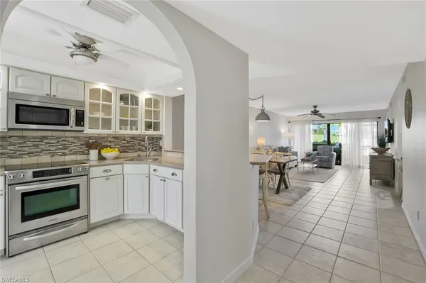 a kitchen with stainless steel appliances granite countertop a stove and a sink
