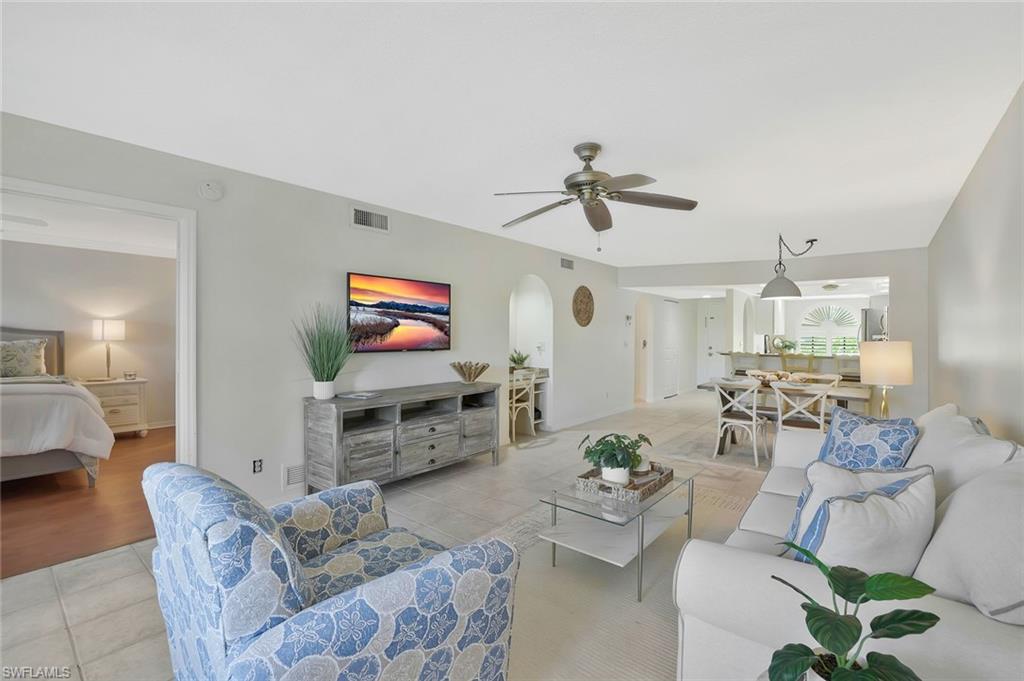 601 Augusta Boulevard, Unit 6014 Naples, FL 34113 - Photo 5 of 31 a living room with furniture and a flat screen tv