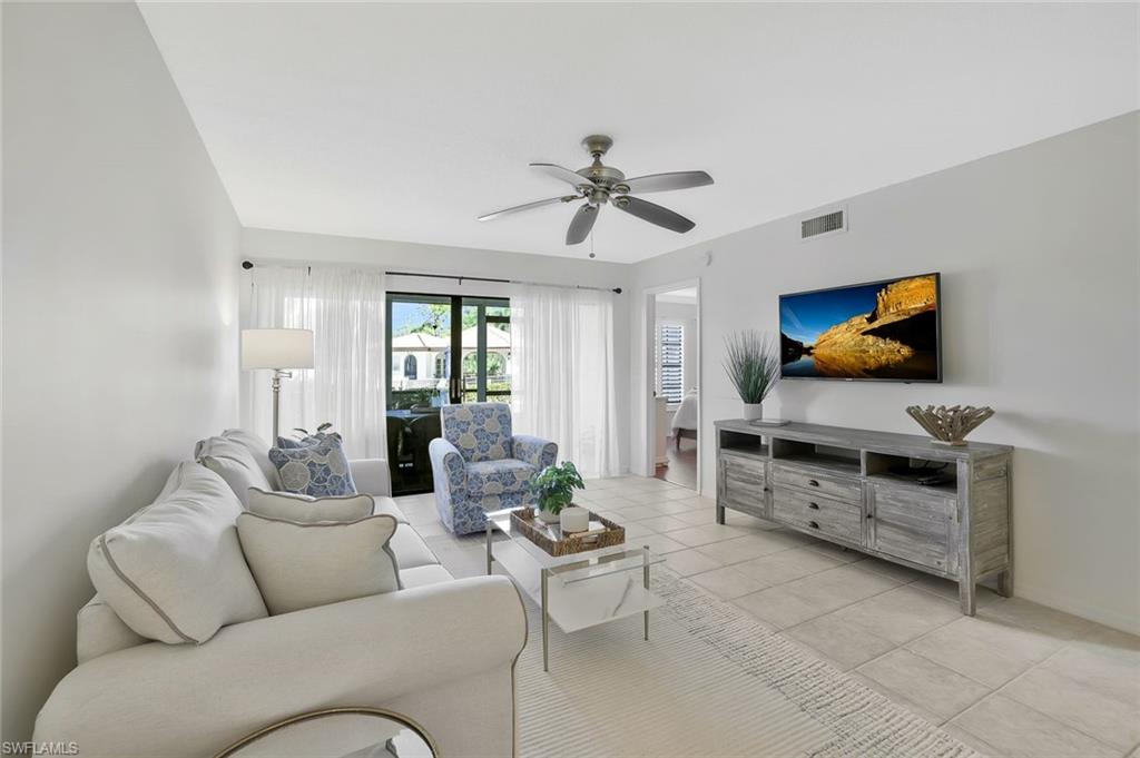 601 Augusta Boulevard, Unit 6014 Naples, FL 34113 - Photo 9 of 31 a living room with furniture and a flat screen tv