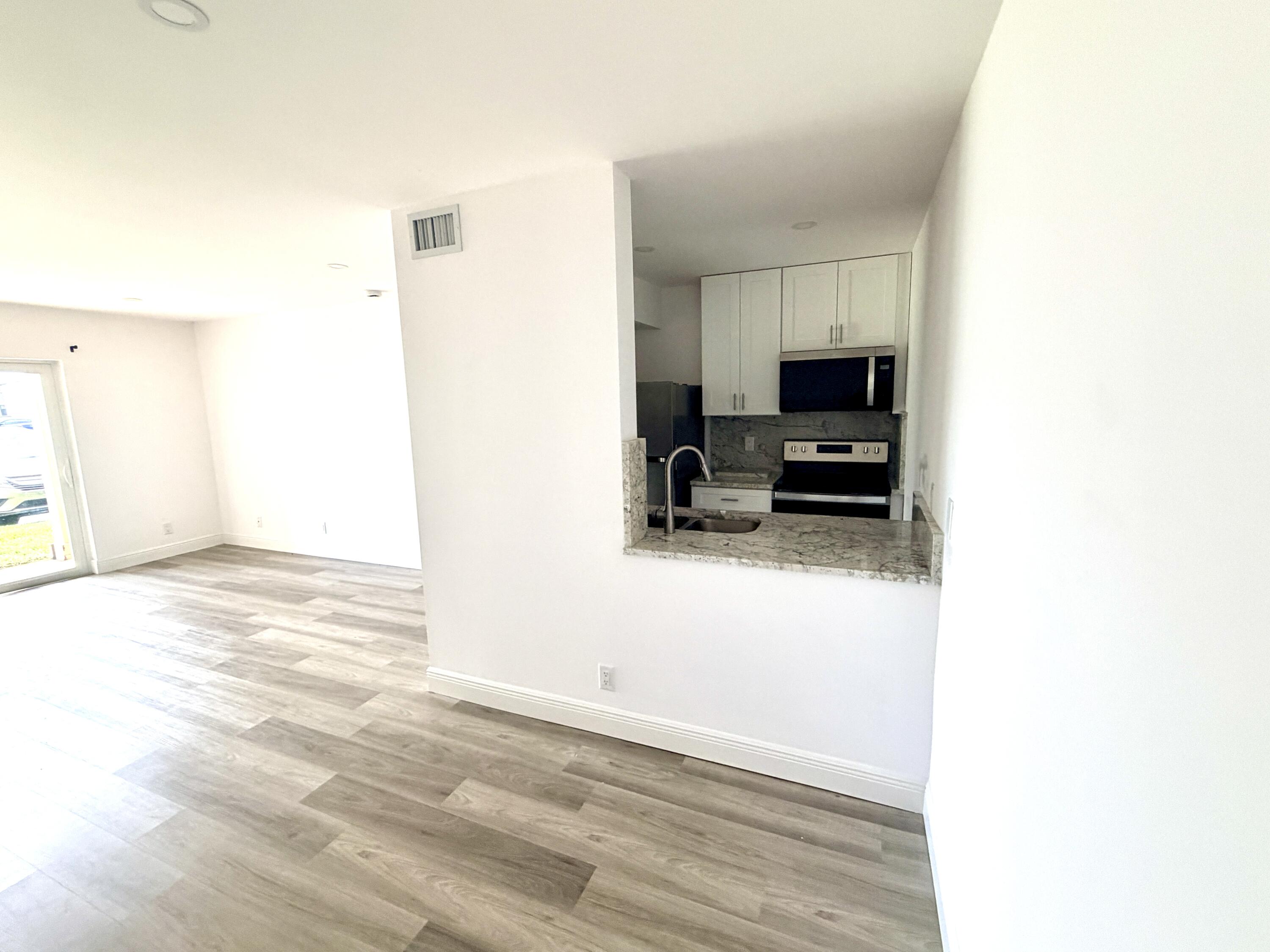 1766 Abbey Road, Unit 105 West Palm Beach, FL 33415 - Photo 7 of 8 ___F105 living 2