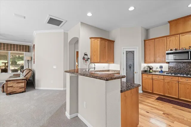 a kitchen with stainless steel appliances granite countertop a refrigerator and a sink