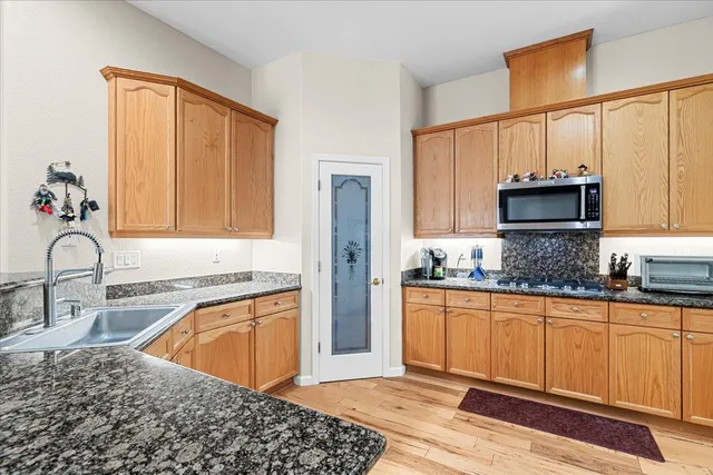 a kitchen with a sink stove and cabinets