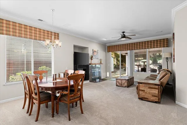 a view of a dining room with furniture and window
