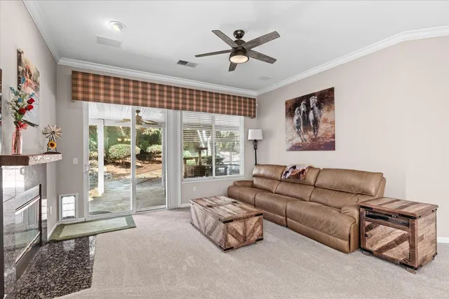 a living room with furniture a table and chairs