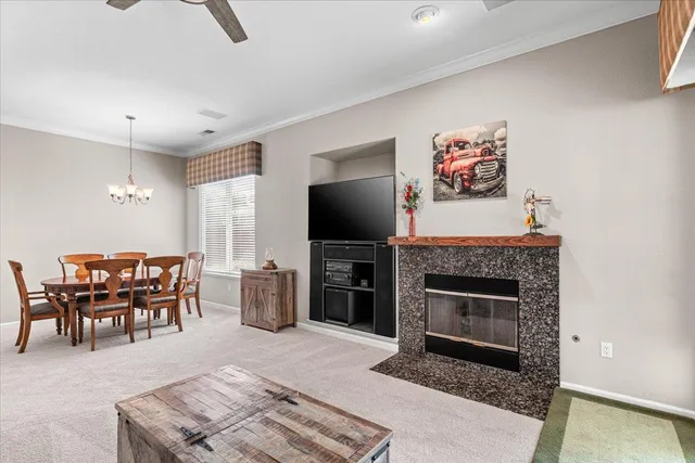 a view of a dining room with furniture and chandelier