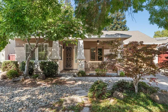 a front view of a house with garden