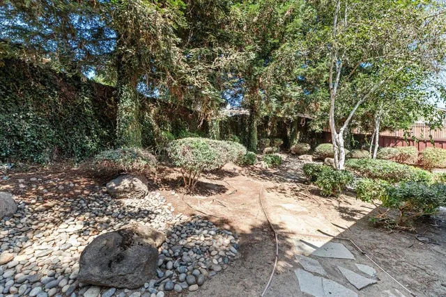 a front view of a house with a yard and seating space