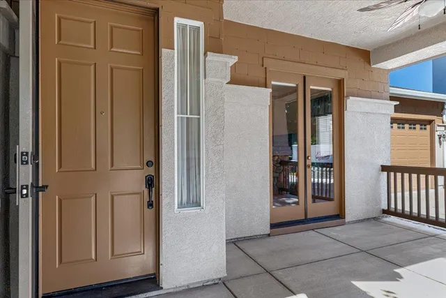 a view of a hallway with wooden floor and a living room