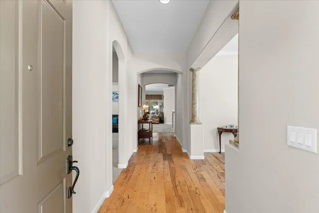 a view of a room with wooden floor and furniture