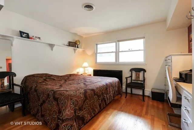 a bedroom with a bed and a table in it