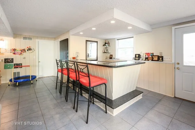 a kitchen with stainless steel appliances granite countertop a sink and cabinets