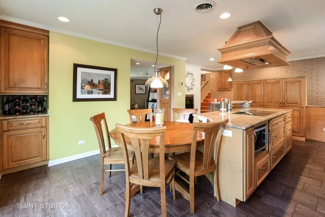 a view of dining table chairs and wooden floor