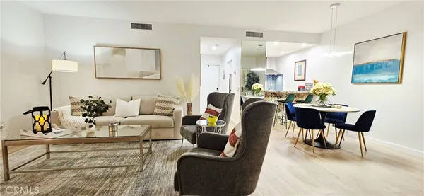 a living room with fireplace furniture and a wooden floor
