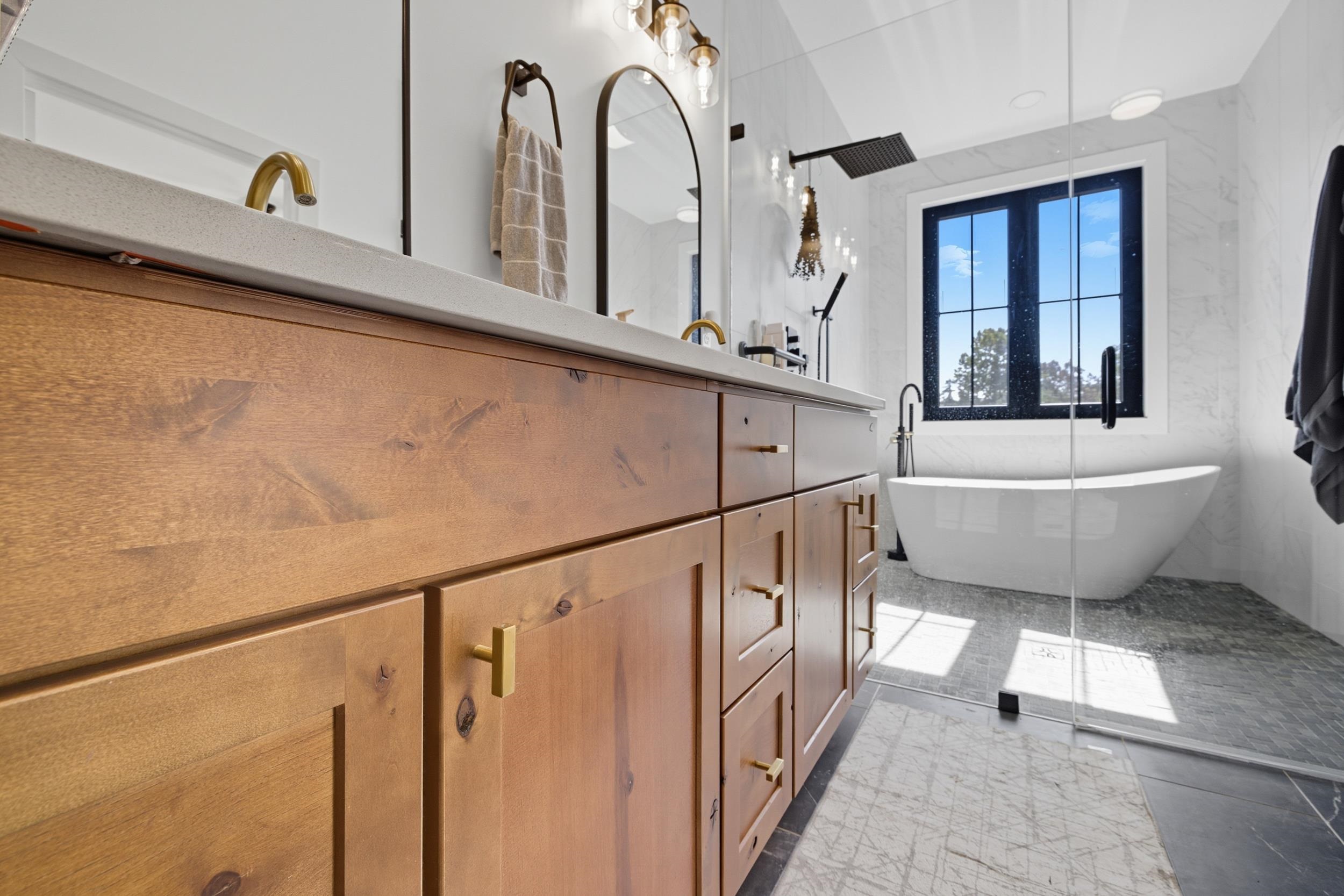 2430 Fadley Road Bridgewater, VA 22812 - Photo 35 of 66 a bathroom with a bathtub a mirror a sink and a window