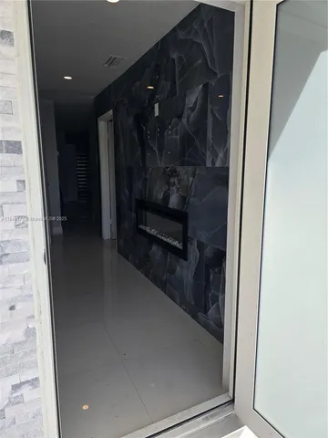 a view of kitchen with granite countertop stove top oven and cabinets