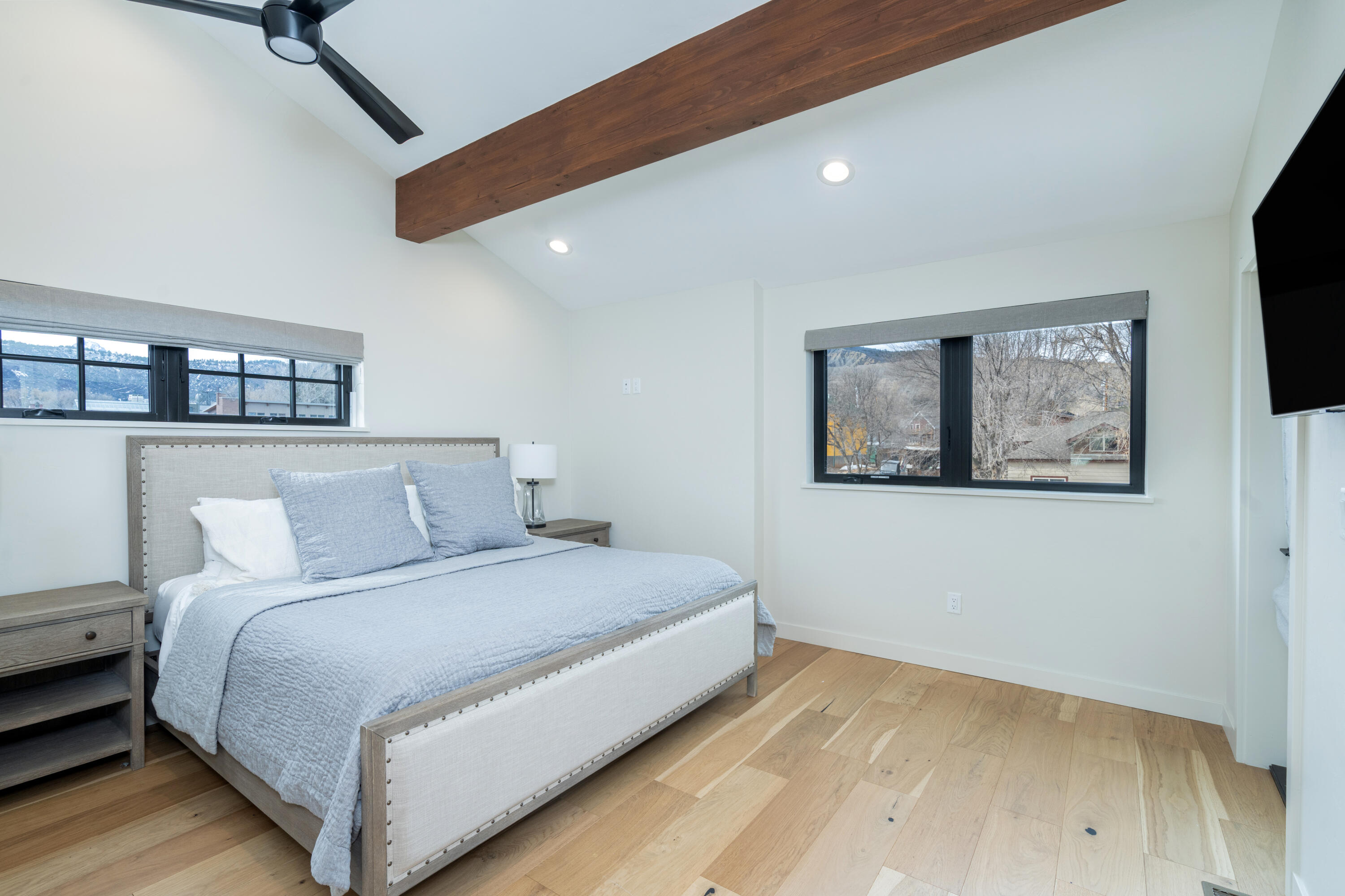 388 North Lena Street, Unit 5C Ridgway, CO 81432 - Photo 7 of 27 a bedroom with a large bed and a flat screen tv