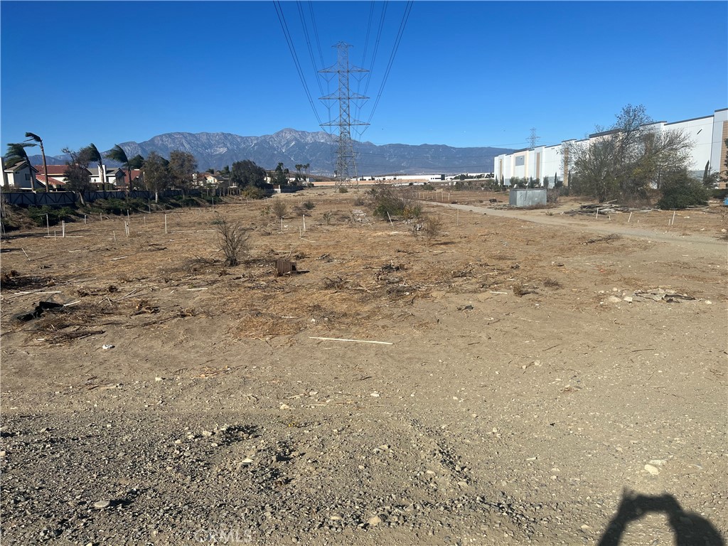 11130 East Riverside Drive Ontario, CA 91761 - Photo 2 of 9 a view of a dry yard with mountains in the background