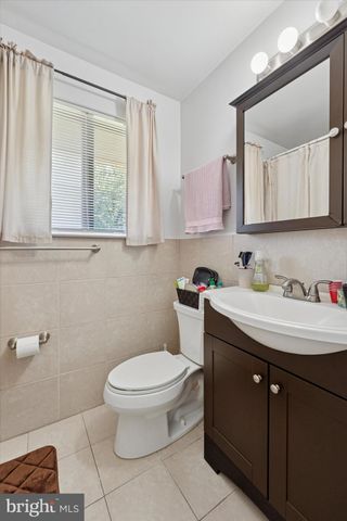 a bathroom with a sink toilet and mirror