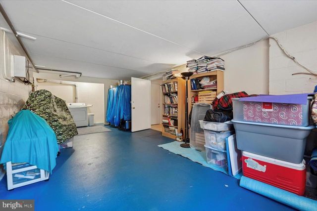 a view of a room with wooden floor and furniture