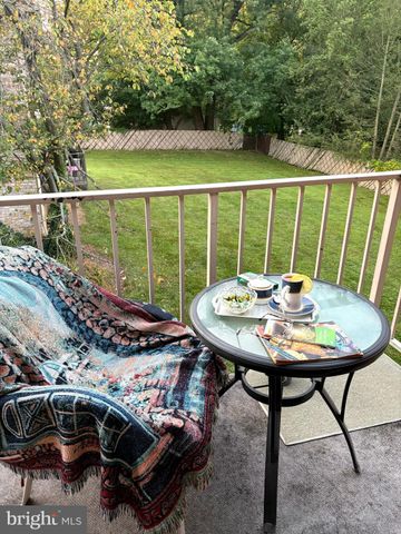 a view of a balcony with table and chairs and wooden floor
