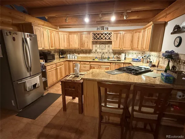 a view of gym equipment with wooden floor