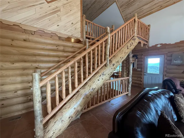 a bedroom with two beds and a chandelier