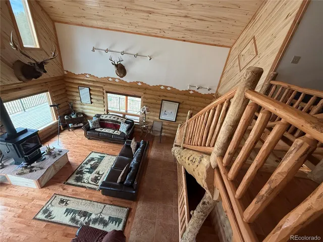 a large bedroom with bed and wooden floor