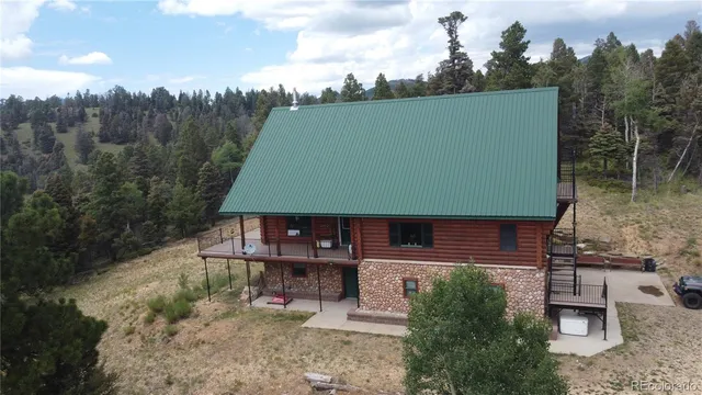 an aerial view of a house with a yard