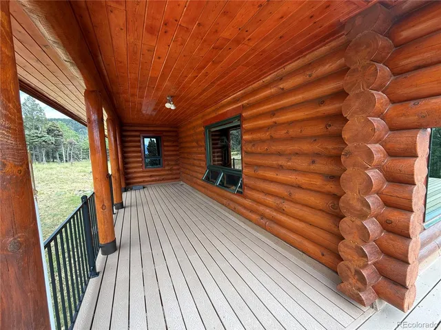 a view of balcony with wooden floor and fence
